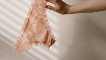 Person Holding a Lace Underwear